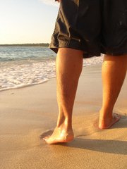 PICTURE OF PERSON WALKING ON BEACH FOR POST TOE SEPARATORS FOR OVERLAPPING TOES