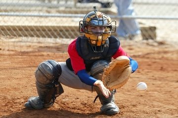 Child playing catcher in baseball for post How to Treat Heel Pain